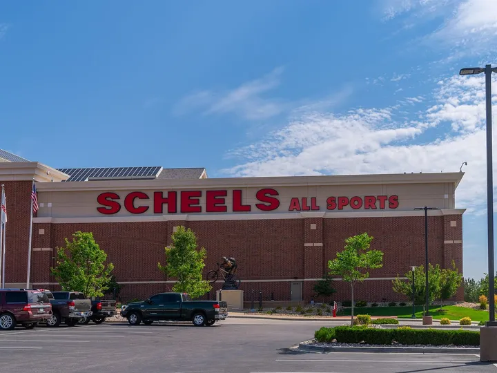 The brick Scheels All Sports store at Johnstown Plaza on a summer day